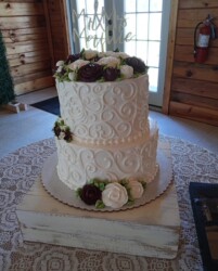 2 tiered wedding cake with buttercream flowers and swirl decorations